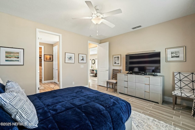 bedroom with baseboards, ceiling fan, visible vents, and wood tiled floor