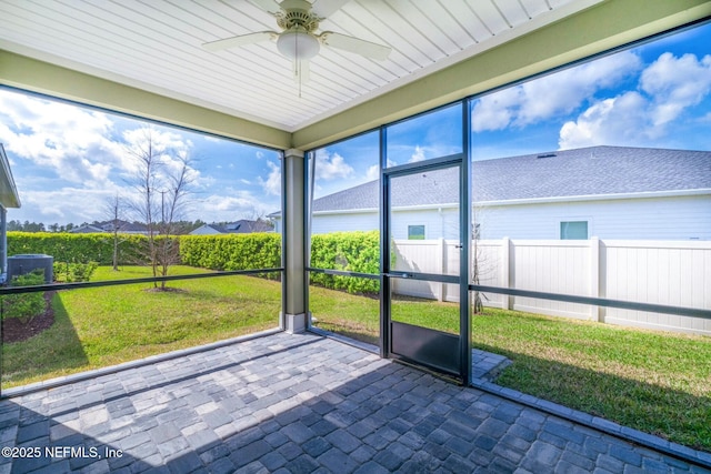 unfurnished sunroom with a ceiling fan