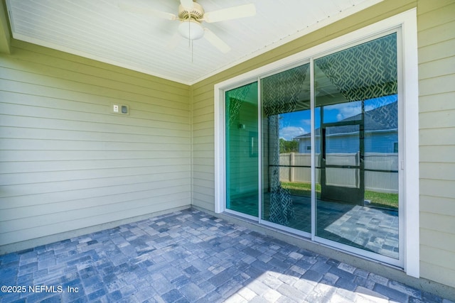 view of patio featuring ceiling fan and fence