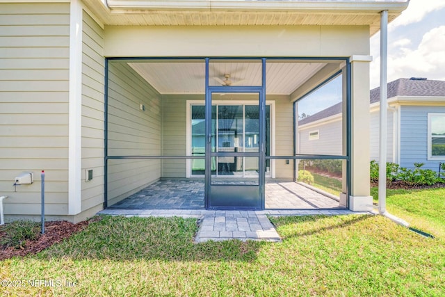 doorway to property with a patio and a yard