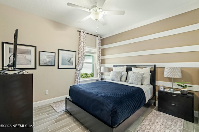 bedroom featuring baseboards, a ceiling fan, and wood finish floors