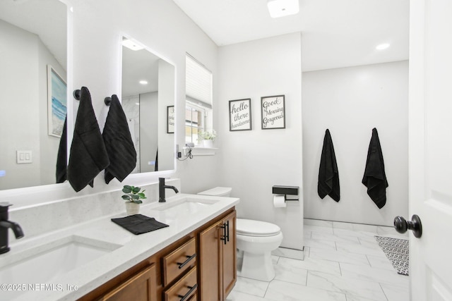 full bathroom with a sink, toilet, marble finish floor, and double vanity