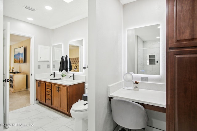 full bathroom featuring visible vents, marble finish floor, a tile shower, and a sink