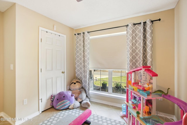 recreation room featuring tile patterned flooring and baseboards