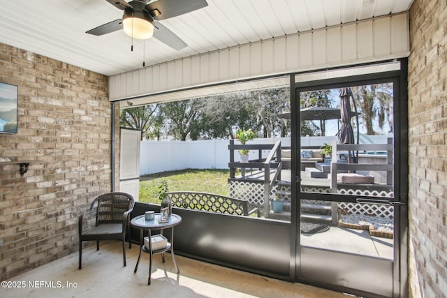 sunroom with a wealth of natural light and a ceiling fan