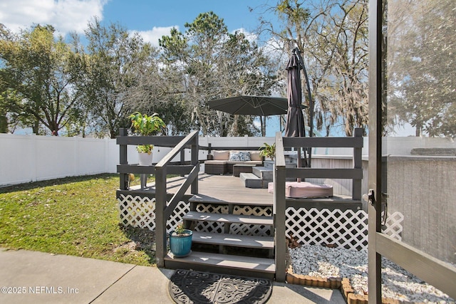 wooden deck featuring a yard and fence