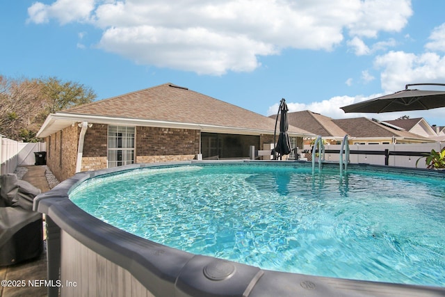 view of swimming pool featuring a fenced in pool and fence