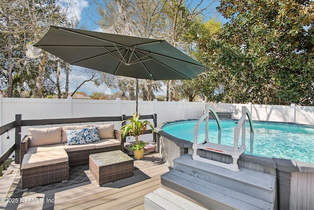 wooden terrace with an outdoor living space, a fenced in pool, and a fenced backyard