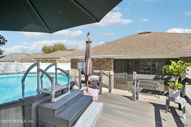 deck featuring a fenced in pool and fence