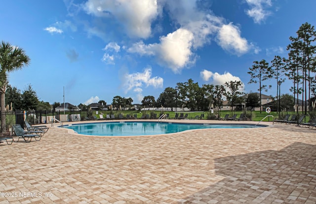 pool featuring a patio area and fence