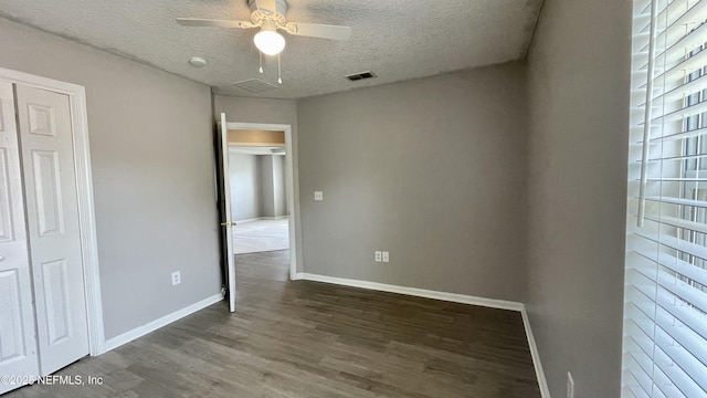 unfurnished bedroom featuring baseboards, visible vents, a ceiling fan, wood finished floors, and a textured ceiling