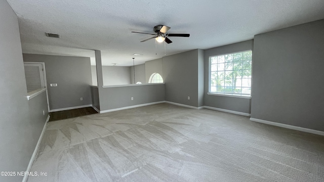 empty room featuring baseboards, visible vents, ceiling fan, and carpet flooring