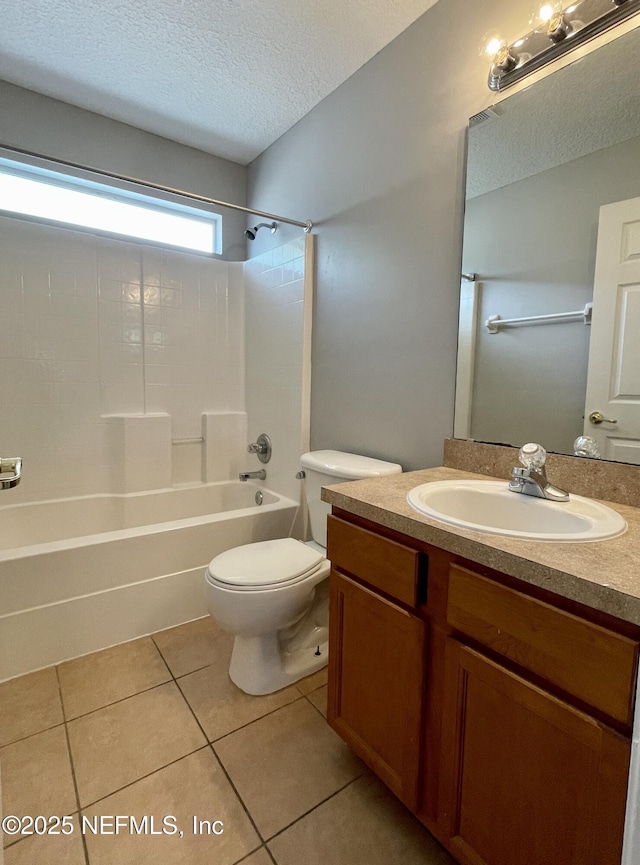 full bathroom featuring shower / washtub combination, toilet, vanity, a textured ceiling, and tile patterned floors