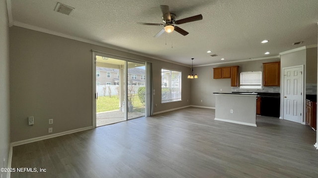 interior space featuring open floor plan, dark wood-style flooring, dark countertops, and a kitchen island