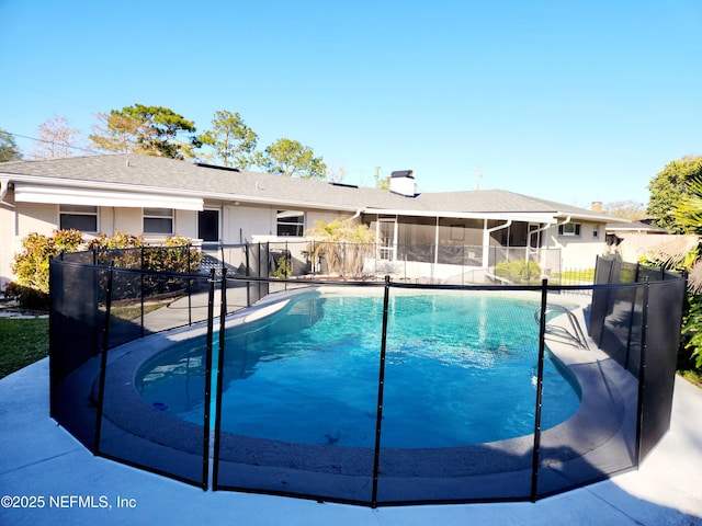 view of pool with a fenced in pool, a sunroom, and fence