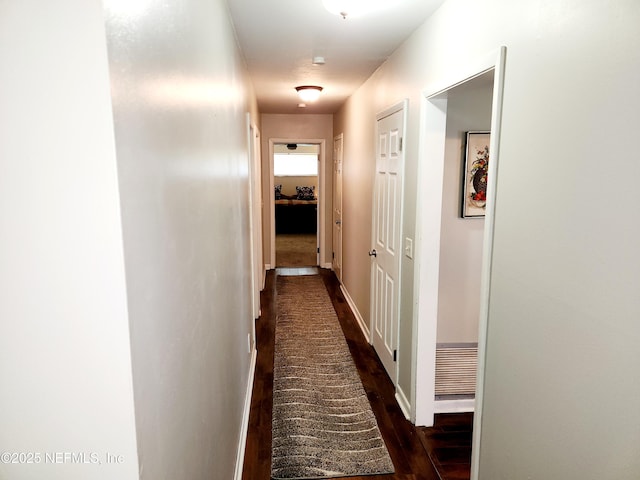 hall with wood finished floors and baseboards