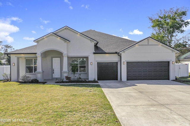 ranch-style house with concrete driveway, an attached garage, fence, and a front yard