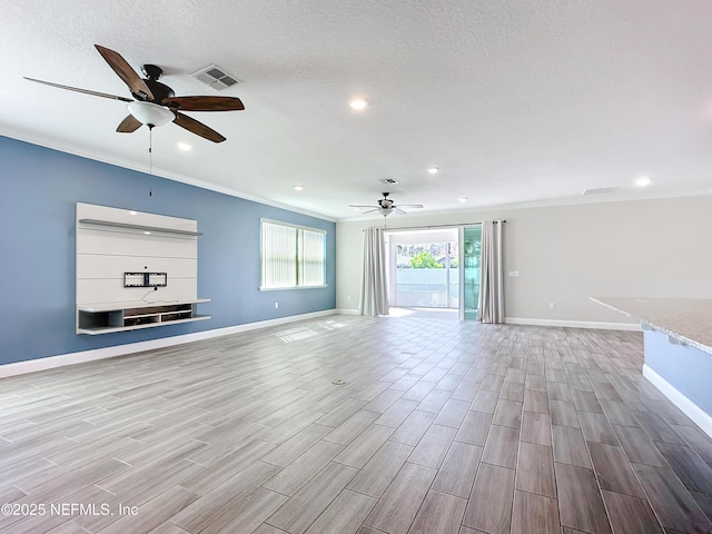 unfurnished living room with baseboards, wood tiled floor, visible vents, and crown molding