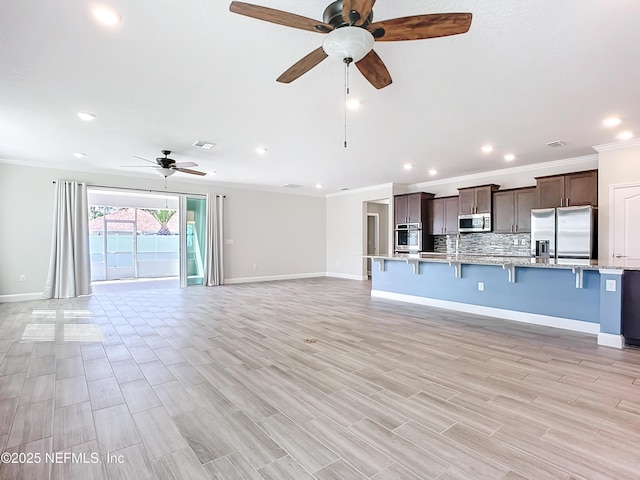 unfurnished living room with baseboards, a ceiling fan, crown molding, light wood-type flooring, and recessed lighting