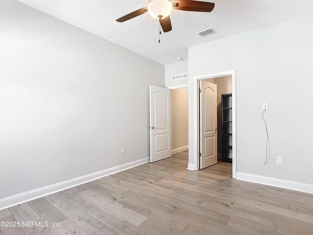 unfurnished bedroom featuring light wood-type flooring, visible vents, and baseboards