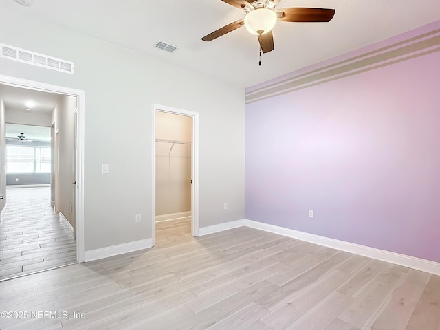 unfurnished bedroom featuring light wood-type flooring, visible vents, and baseboards