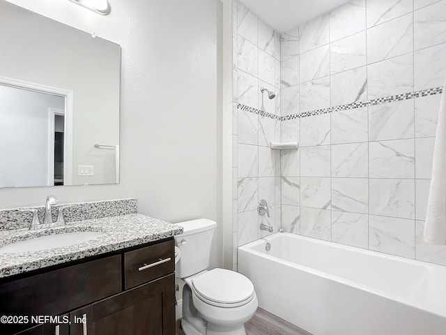 bathroom with toilet, washtub / shower combination, and vanity