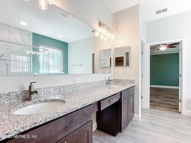 full bathroom with double vanity, a sink, and visible vents