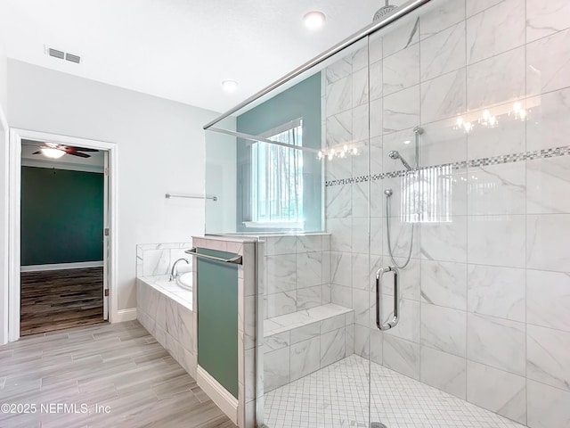 full bath featuring visible vents, baseboards, a garden tub, wood tiled floor, and a shower stall