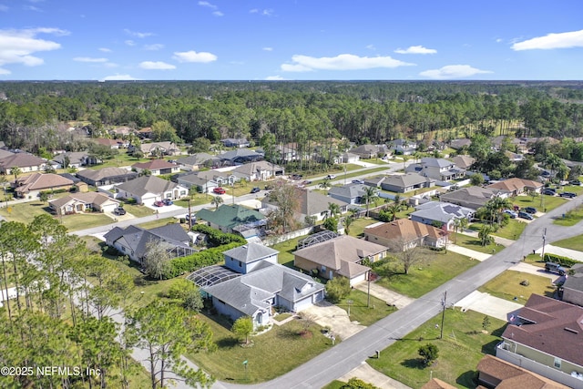 birds eye view of property with a residential view and a view of trees