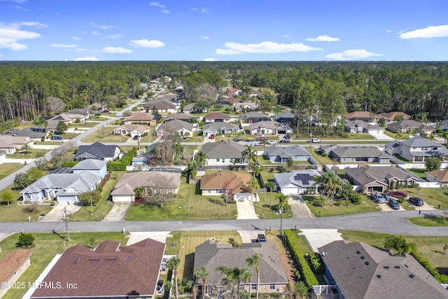 aerial view with a wooded view and a residential view