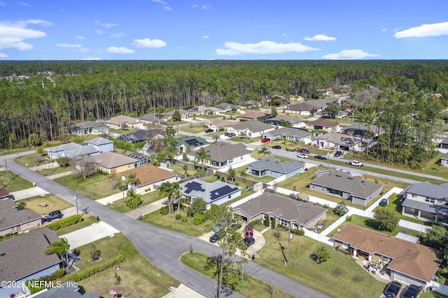 birds eye view of property featuring a residential view and a view of trees