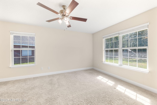 spare room featuring carpet flooring, ceiling fan, and baseboards