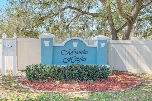 community sign featuring fence