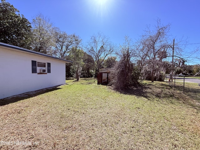 view of yard featuring a storage shed and an outdoor structure