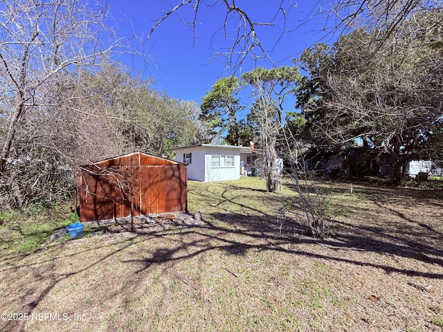 view of yard with an outbuilding and a storage shed