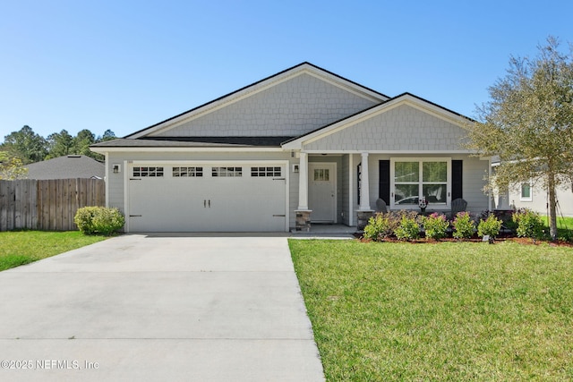 craftsman-style house featuring a garage, driveway, a front lawn, and fence