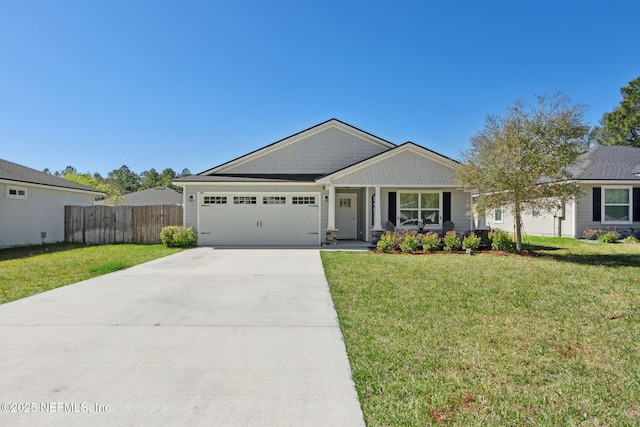 view of front of property with a garage, fence, concrete driveway, and a front yard