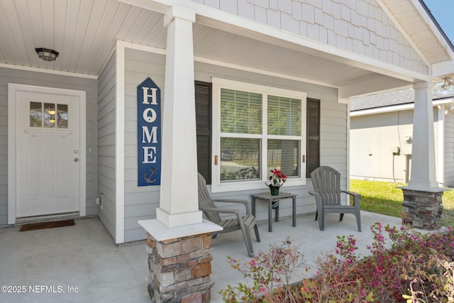 view of exterior entry featuring a porch