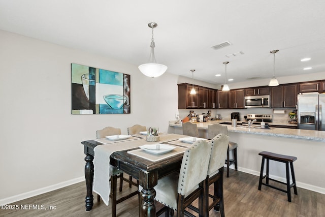 dining area with visible vents, baseboards, dark wood finished floors, and recessed lighting