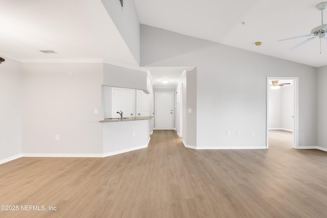10961 Burnt Mill Rd Unit 935, Jacksonville, FL 32256 - unfurnished living room with a ceiling fan, vaulted ceiling, baseboards, and light wood-style flooring