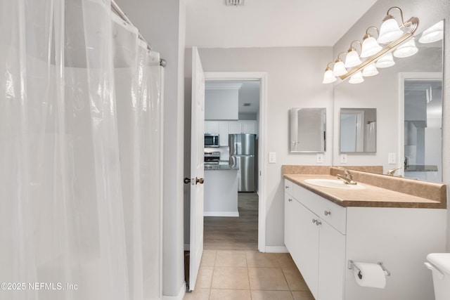 10961 Burnt Mill Rd Unit 935, Jacksonville, FL 32256 - bathroom featuring tile patterned flooring, toilet, vanity, and baseboards