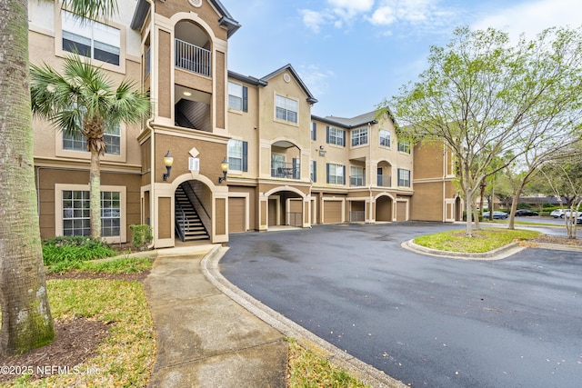 view of property featuring an attached garage and driveway