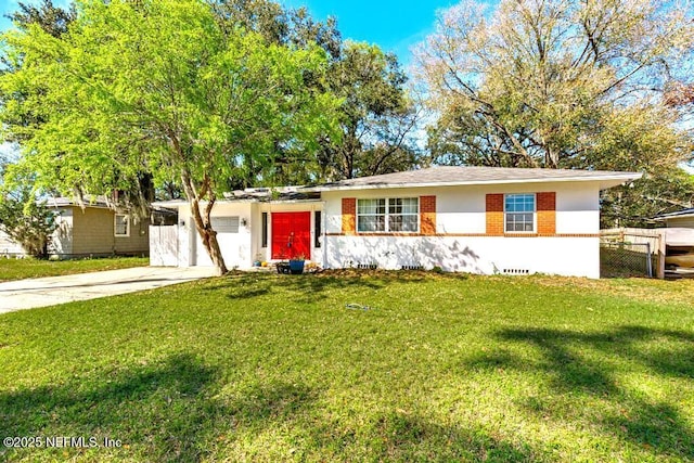 ranch-style house featuring a front yard, concrete driveway, and fence