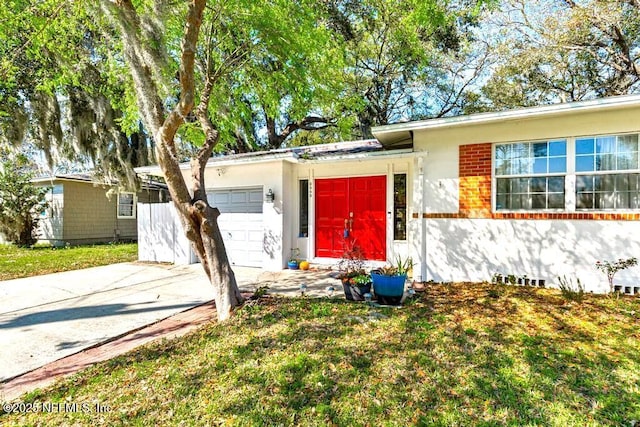 single story home with concrete driveway and an attached garage