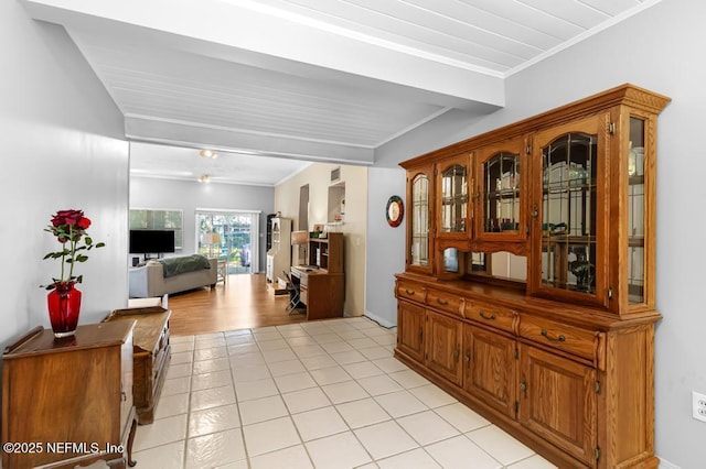 interior space with light tile patterned flooring and crown molding