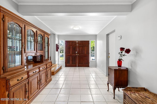 foyer featuring light tile patterned floors and baseboards