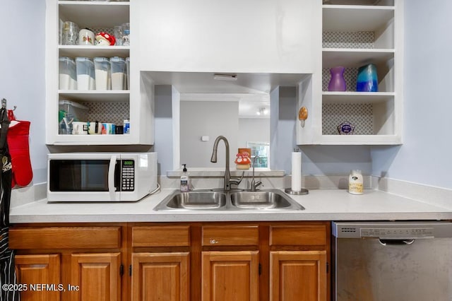 kitchen with white microwave, open shelves, light countertops, stainless steel dishwasher, and a sink