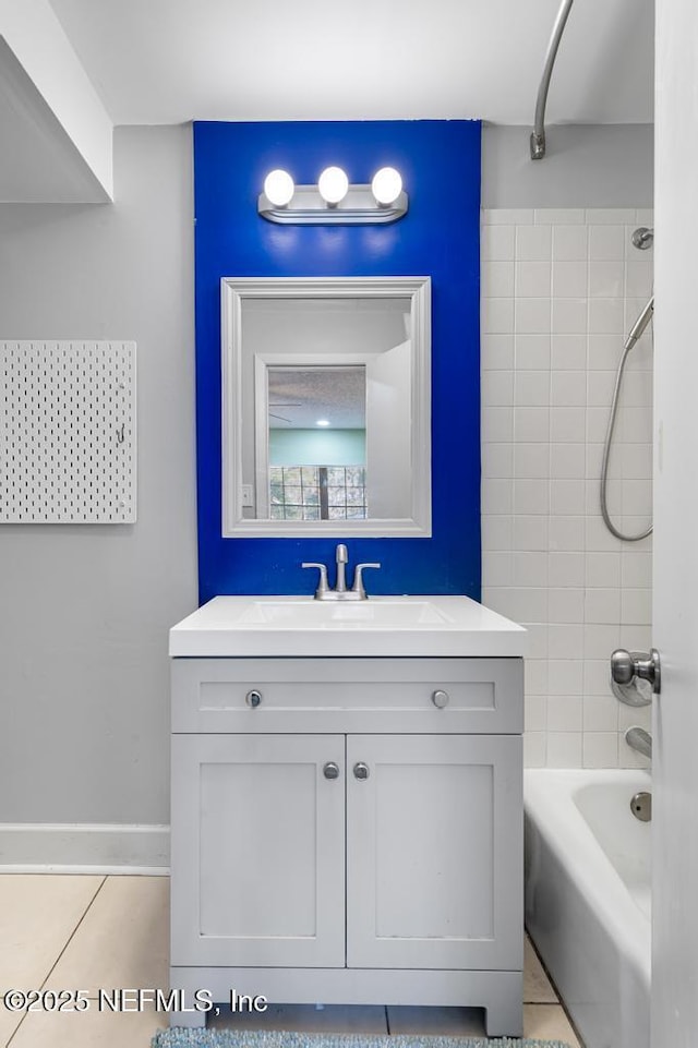 full bath featuring tile patterned flooring, vanity, and shower / bathtub combination