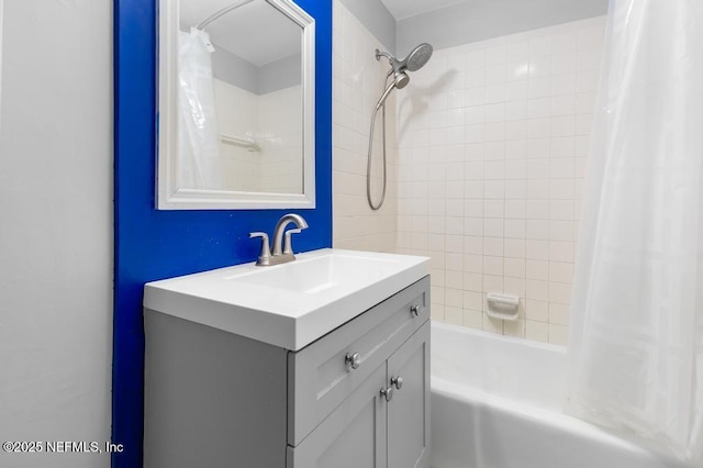 bathroom featuring vanity and shower / bathtub combination with curtain