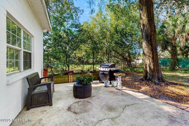 view of patio / terrace featuring area for grilling and fence